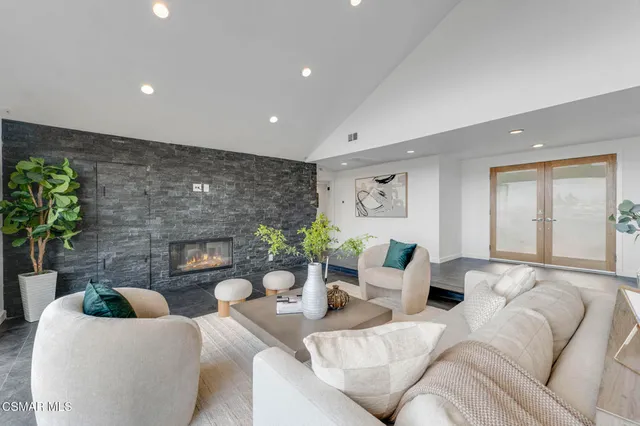 a living room with furniture potted plant and a fireplace