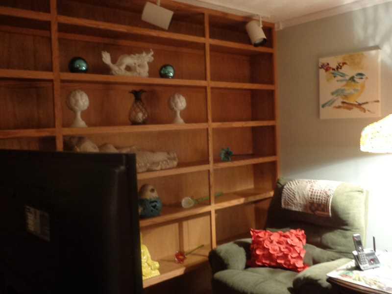 Den. Cozy Den, with Floor to Ceiling Bookshelves. Great place to snuggle on a cold, Winters night.