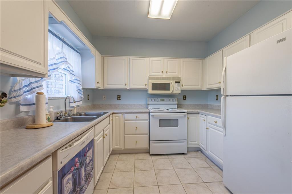 61 David Drive Lower Burrell, PA 15068 - Photo 11 of 29 a kitchen with a sink a stove top oven and white stainless steel appliances
