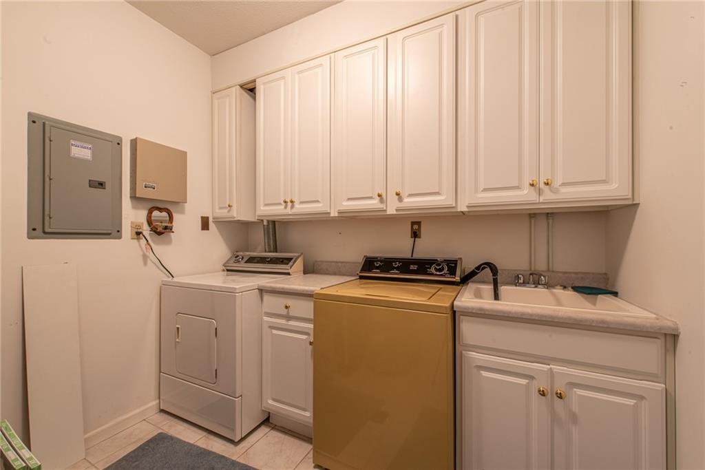 61 David Drive Lower Burrell, PA 15068 - Photo 25 of 29 a kitchen with stainless steel appliances granite countertop a sink a stove and white cabinets