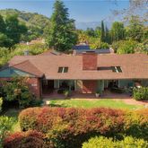 an aerial view of a house with yard swimming pool and outdoor seating