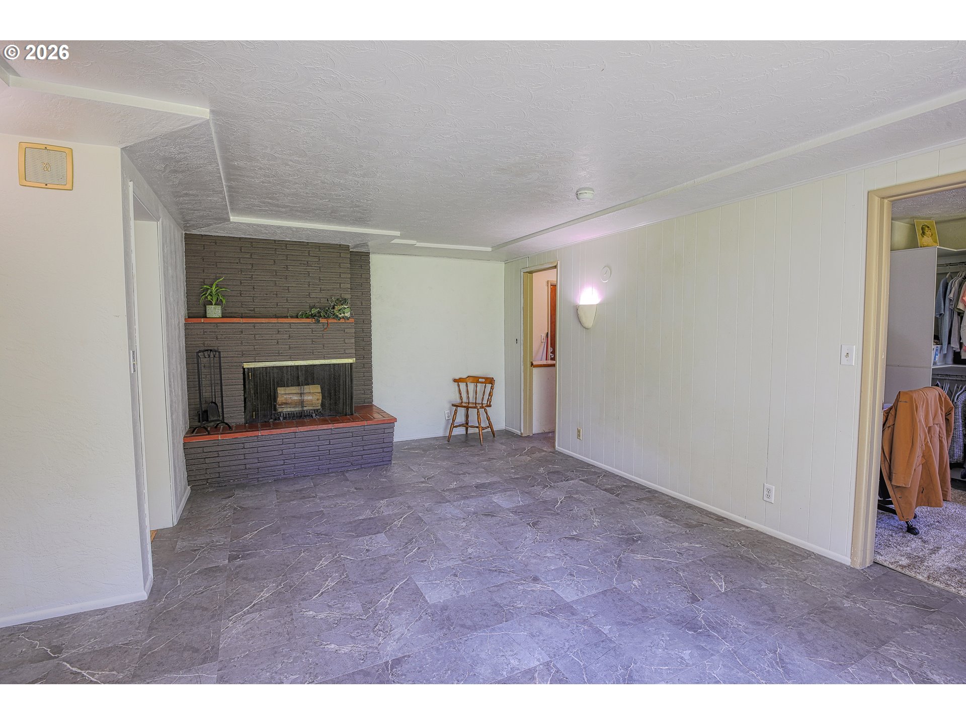 7077 Main Street Springfield, OR 97478 - Photo 9 of 34 a view of empty room with a fireplace