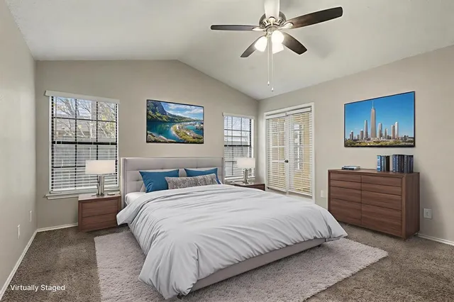 a bedroom with a large bed and a chandelier