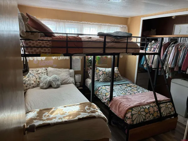 a bedroom with two beds and a flat screen tv