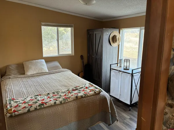 a bedroom with a bed and a window