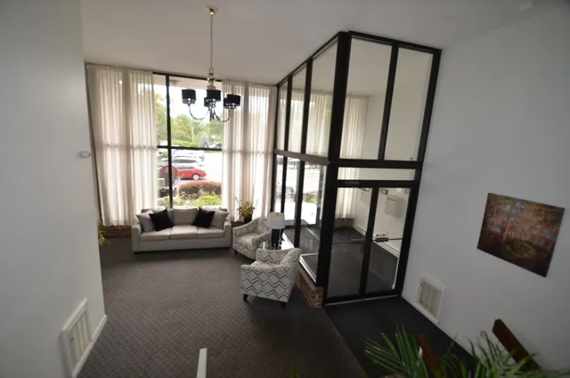 a living room with furniture tv and a window