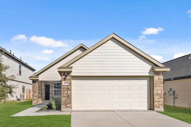 a view of a white house next to a yard with palm trees