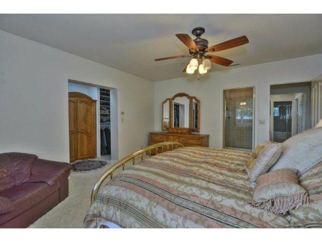 3852 Higuera Road San Jose, CA 95148 - Photo 11 of 25 a bedroom with a bed and a chandelier