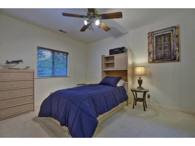 3852 Higuera Road San Jose, CA 95148 - Photo 14 of 25 a bedroom with a bed window and a chandelier