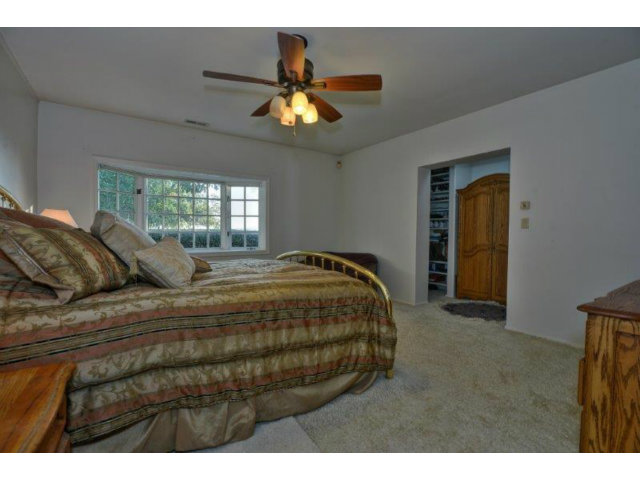 3852 Higuera Road San Jose, CA 95148 - Photo 10 of 25 a bedroom with a bed and a chandelier