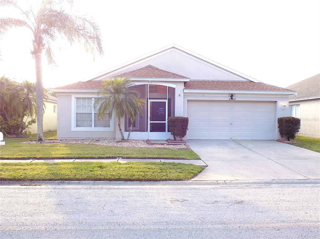 25417 Lexington Oaks Boulevard Wesley Chapel, FL 33544 - Photo 1 of 21 a front view of a house with a yard and garage