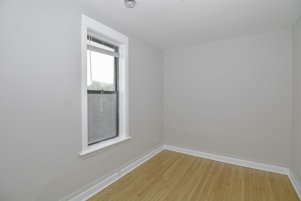2230 West Iowa Street, Unit 3 Chicago, IL 60622 - Photo 13 of 19 a view of an empty room with wooden floor and a window