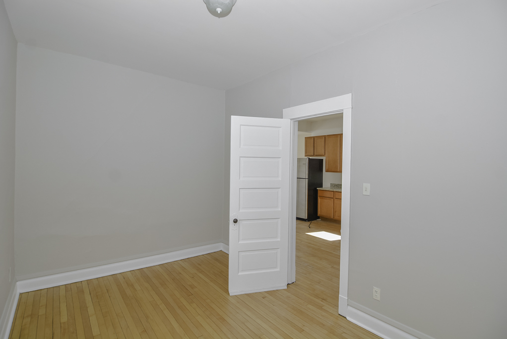 2230 West Iowa Street, Unit 3 Chicago, IL 60622 - Photo 14 of 19 a view of an empty room with wooden floor and a window