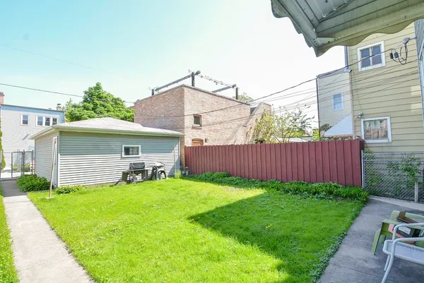 a view of a house with a yard and sitting area