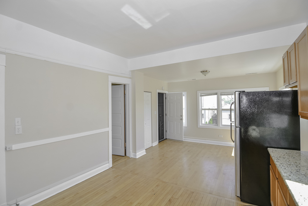2230 West Iowa Street, Unit 3 Chicago, IL 60622 - Photo 4 of 19 a view of a kitchen with a refrigerator cabinets and a window