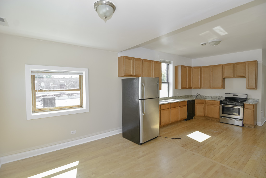 2230 West Iowa Street, Unit 3 Chicago, IL 60622 - Photo 5 of 19 a kitchen with stainless steel appliances granite countertop a refrigerator a stove a sink and a microwave
