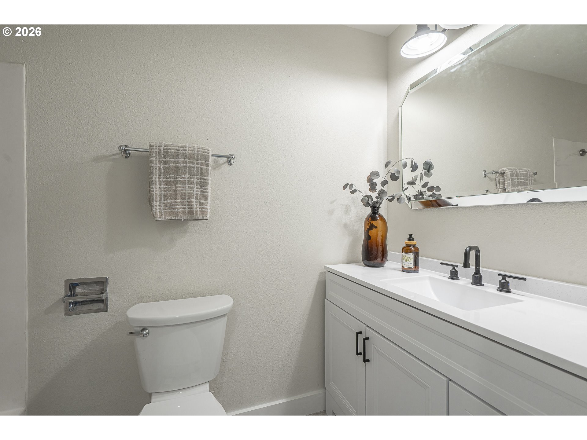8315 Southwest Shenandoah Way Tualatin, OR 97062 - Photo 16 of 29 a bathroom with a sink a toilet and mirror