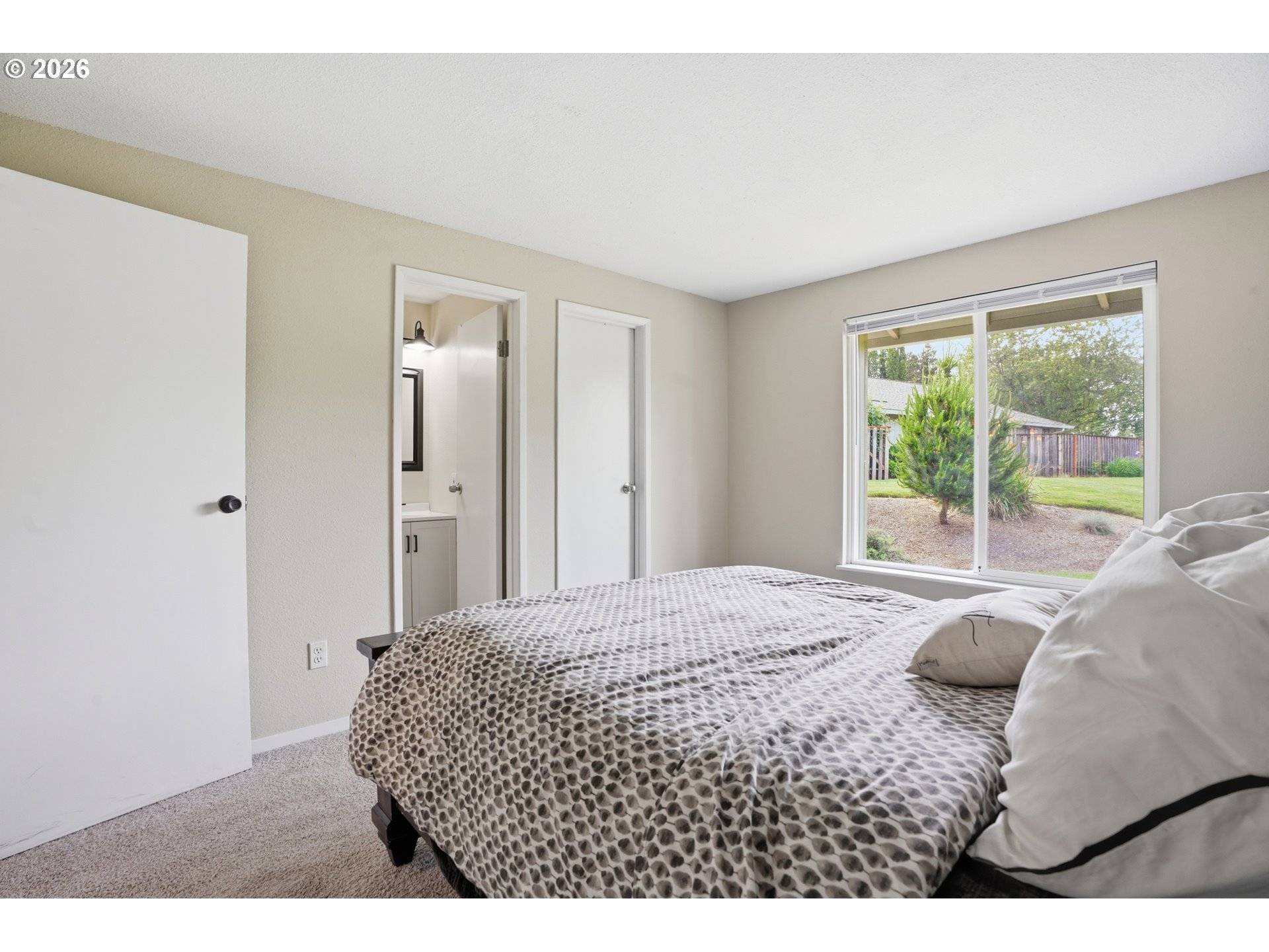 8315 Southwest Shenandoah Way Tualatin, OR 97062 - Photo 26 of 29 a bedroom with a bed cabinet and window