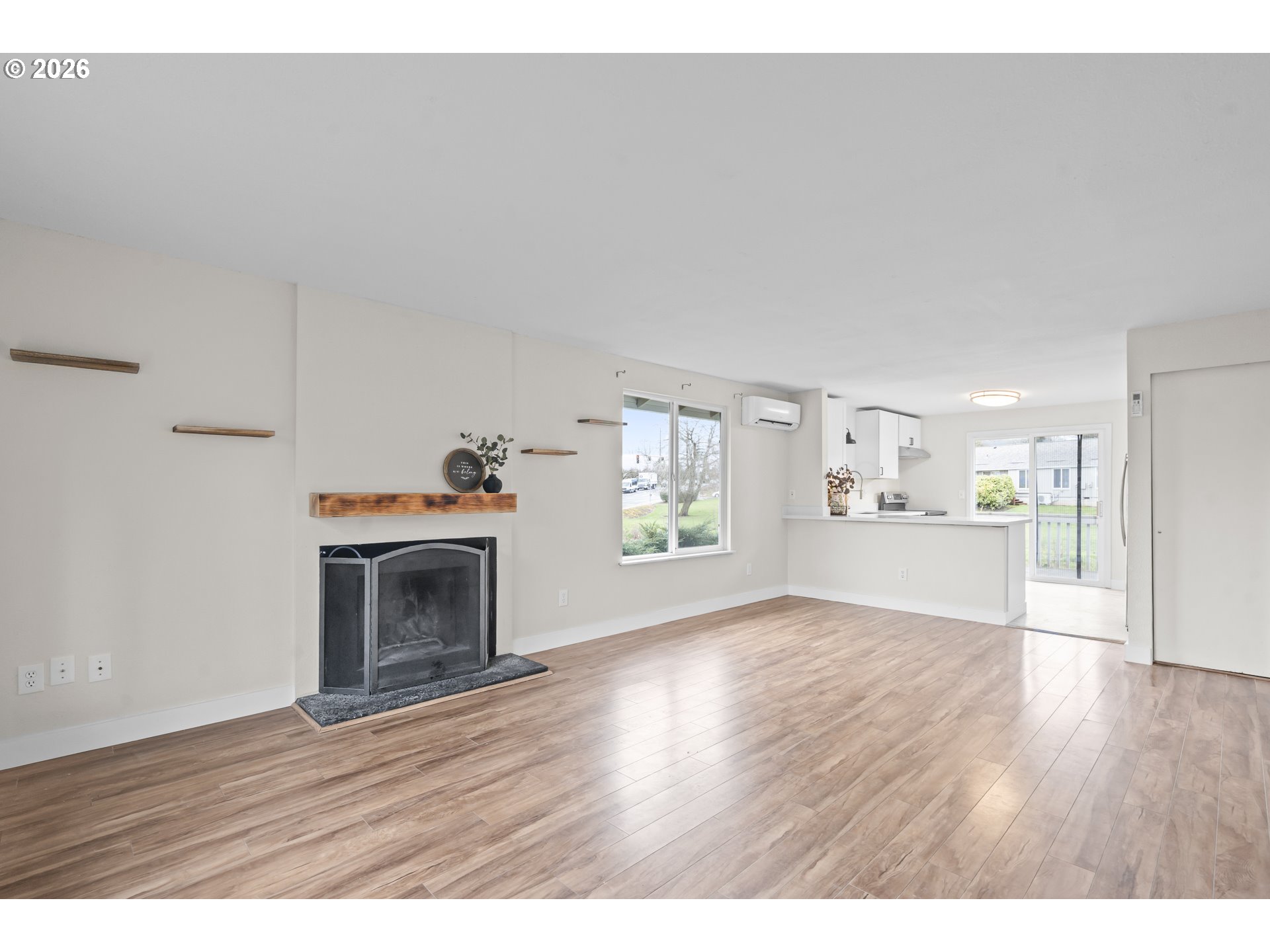 8315 Southwest Shenandoah Way Tualatin, OR 97062 - Photo 3 of 29 a view of empty room with wooden floor and fireplace
