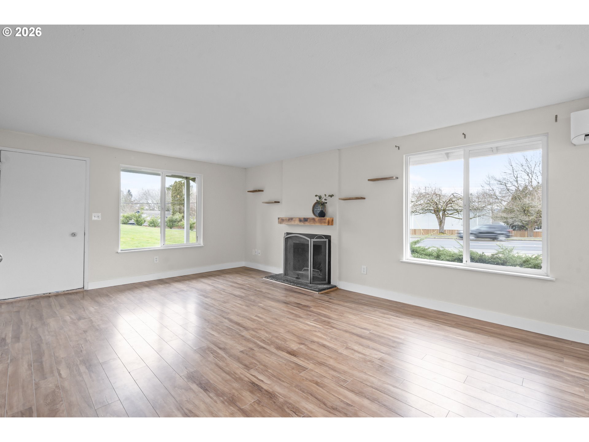 8315 Southwest Shenandoah Way Tualatin, OR 97062 - Photo 6 of 29 a view of an empty room with window and wooden floor