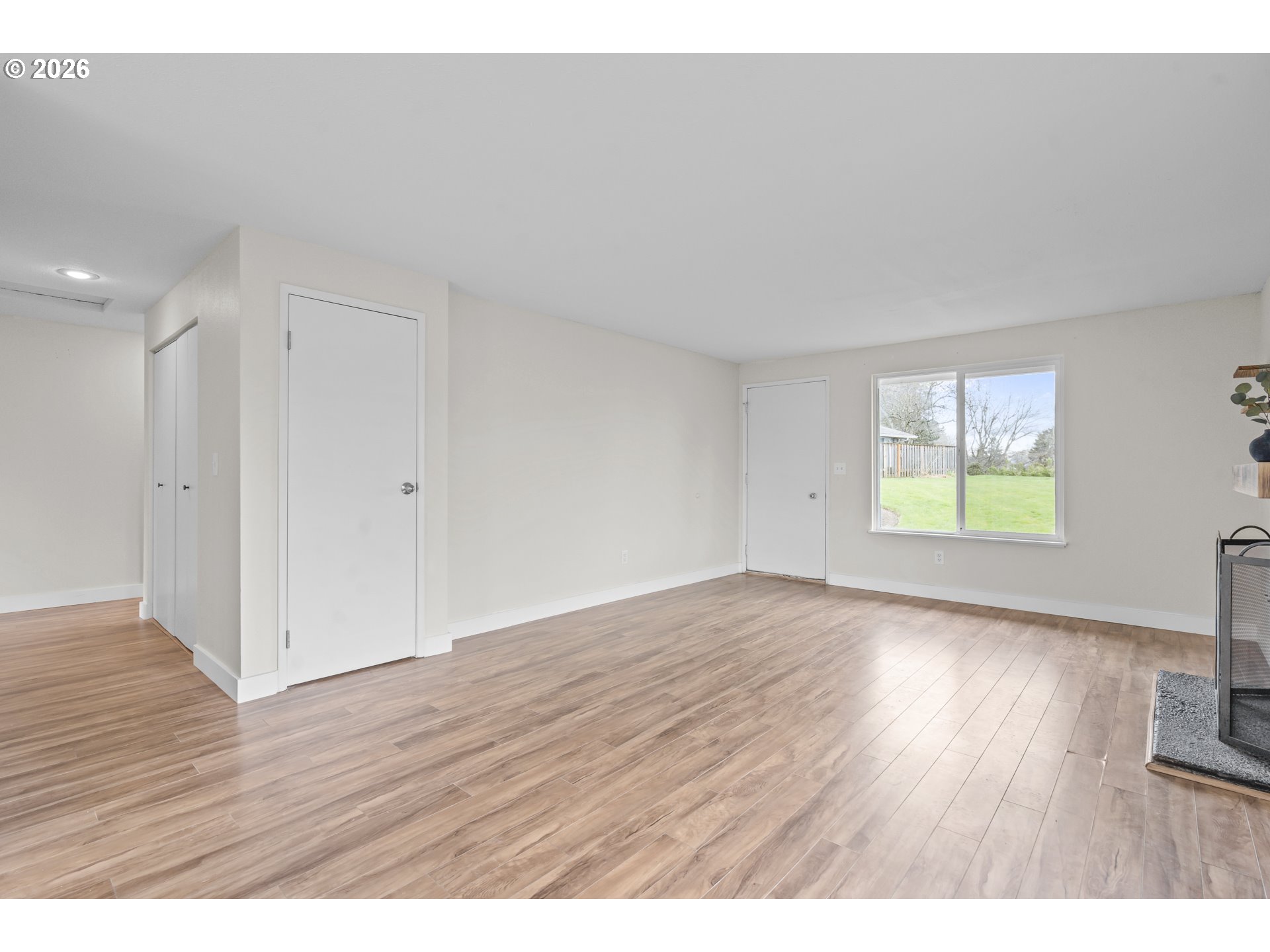 8315 Southwest Shenandoah Way Tualatin, OR 97062 - Photo 7 of 29 a view of an empty room with wooden floor and a window