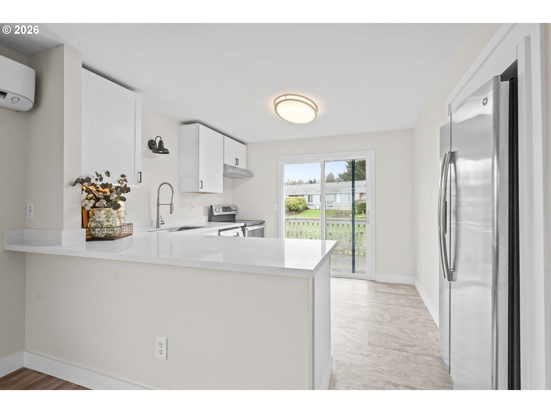 8315 Southwest Shenandoah Way Tualatin, OR 97062 - Photo 8 of 29 a kitchen with stainless steel appliances granite countertop a refrigerator a sink and a cabinets