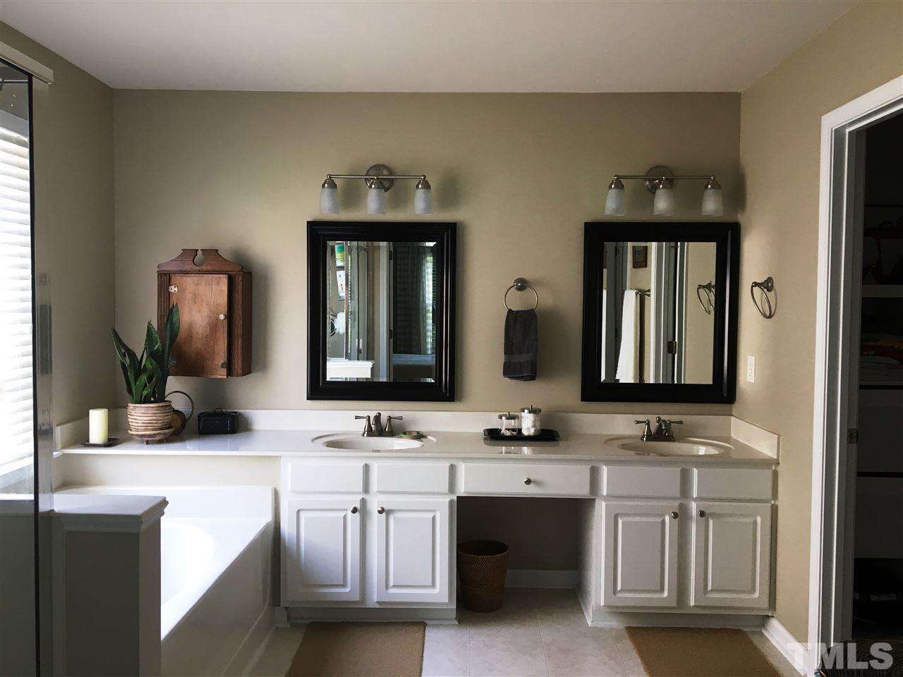 7404 Silver View Lane Raleigh, NC 27613 - Photo 12 of 21 Dual vanities, garden tub, separate shower and generous walk-in closet complete the master suite.