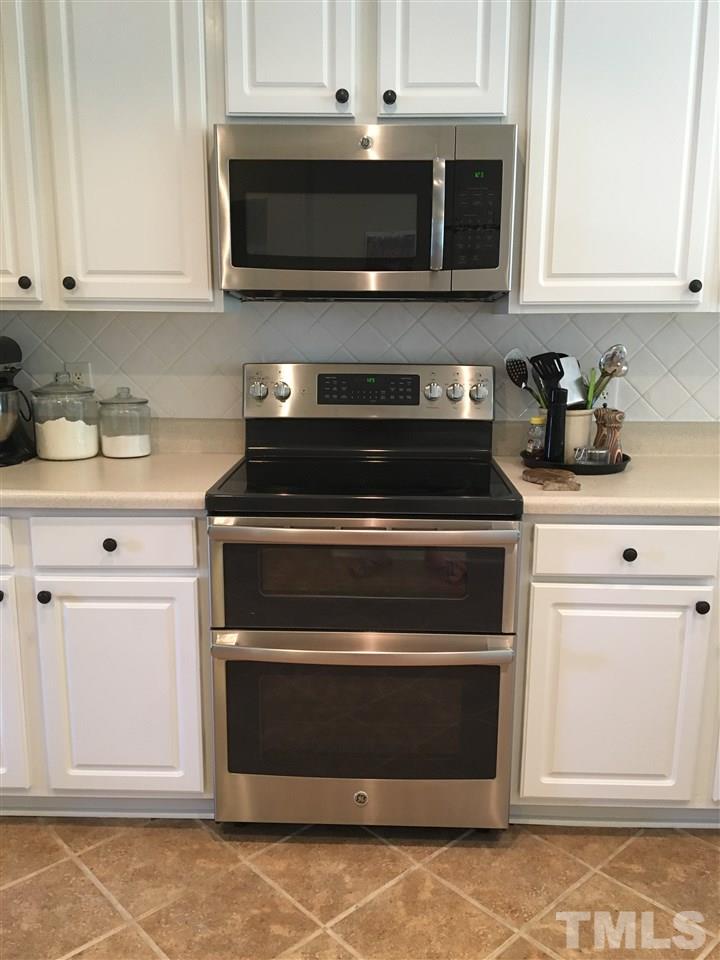 7404 Silver View Lane Raleigh, NC 27613 - Photo 5 of 21 The range is mere months old and the microwave only weeks old.