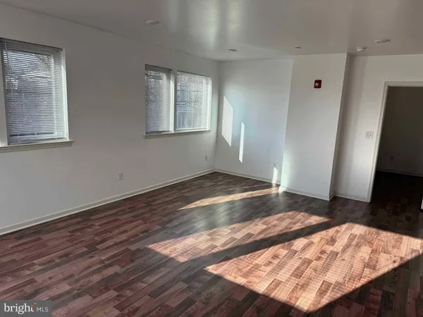 a view of an empty room and wooden floor