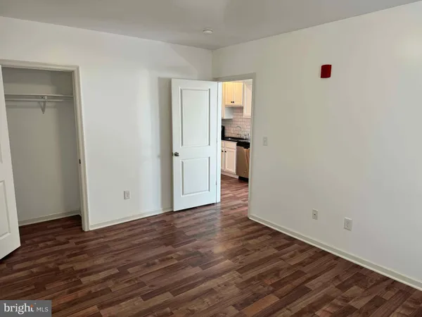 a view of a room with wooden floor and a sink