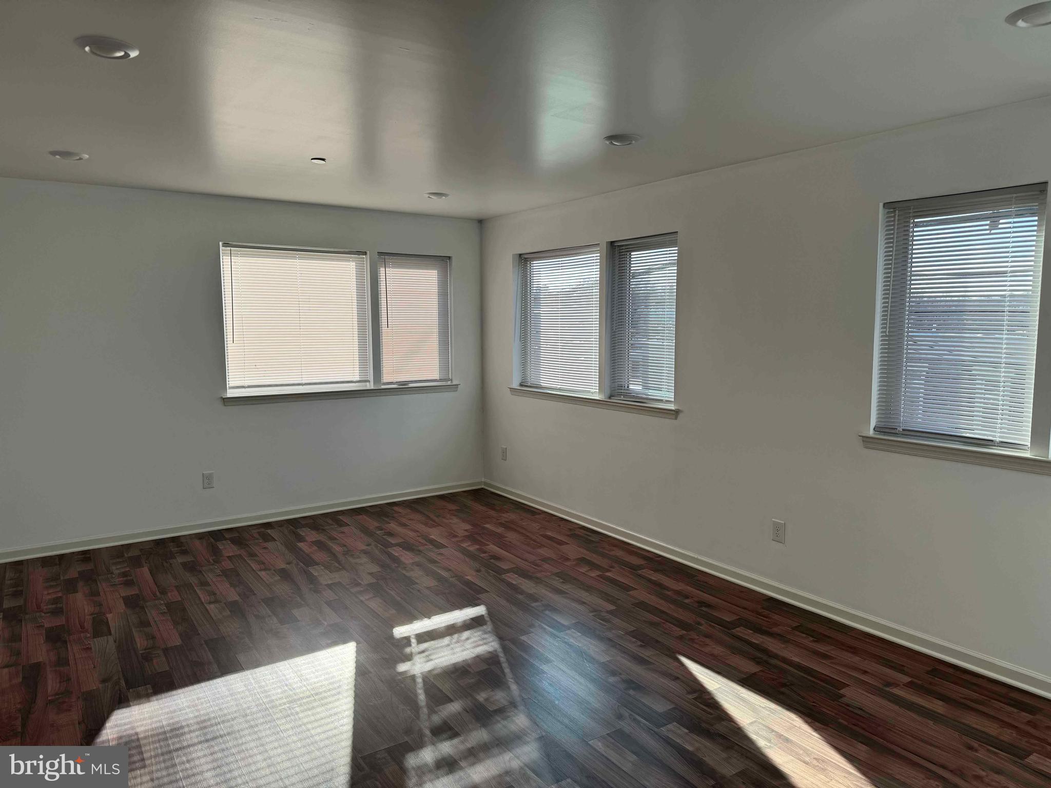 5261 Ridge Avenue, Unit 206 Philadelphia, PA 19128 - Photo 7 of 10 a view of an empty room with wooden floor and a window
