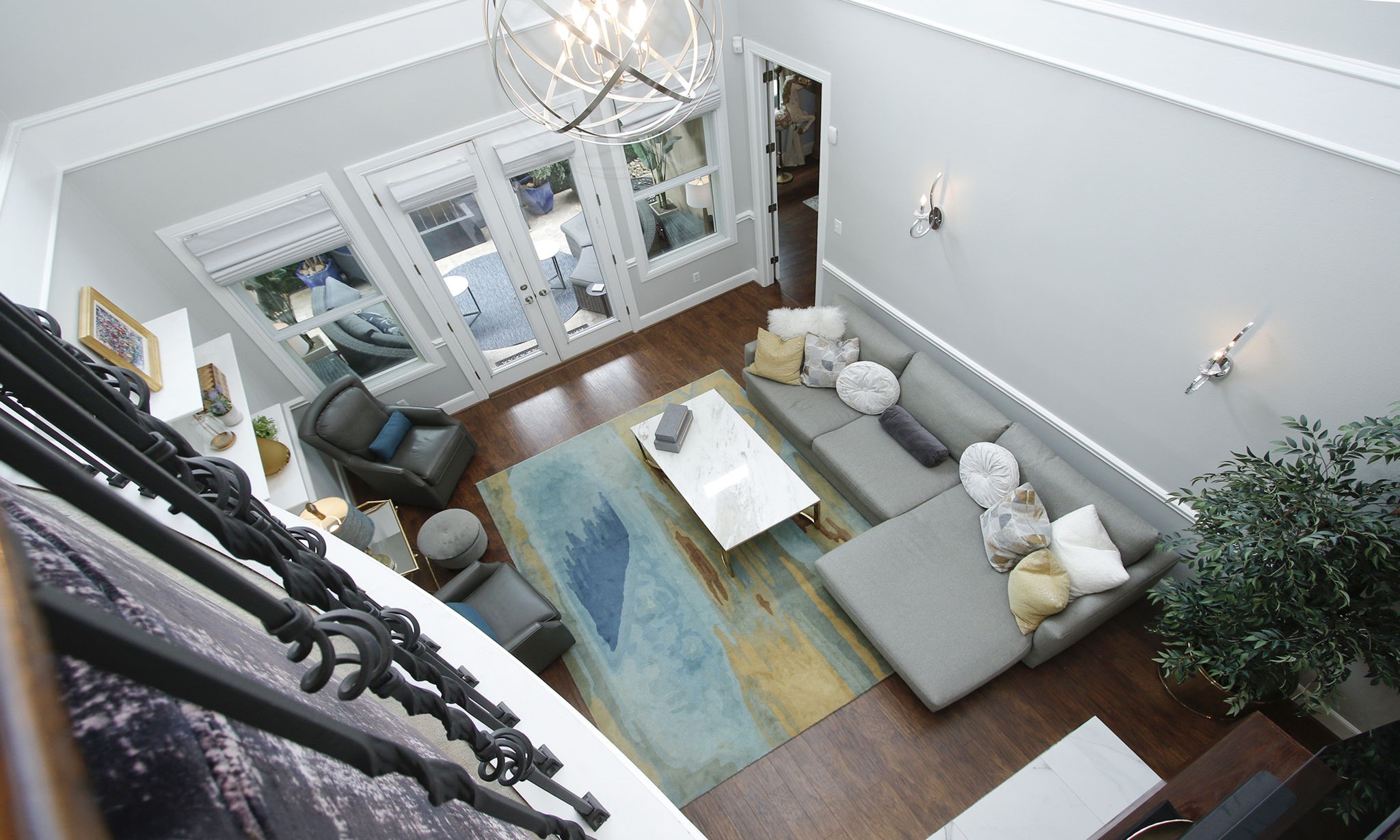 16610 Manningtree Lane Spring, TX 77379 - Photo 33 of 50 This view of the family room shows off the size of the room and the orb goldtone chandelier. The outside patio is visible through the double French doors.
