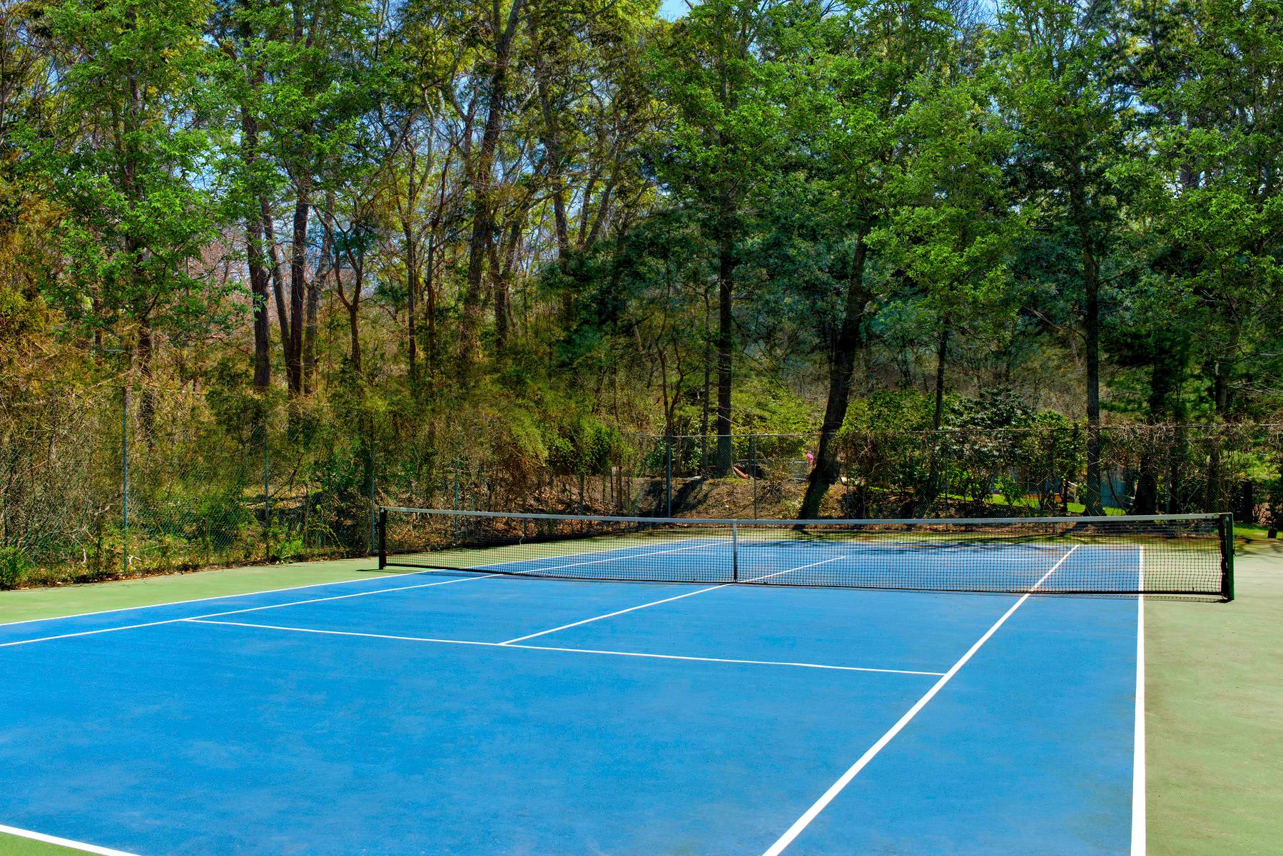 a view of an outdoor space and tennis court