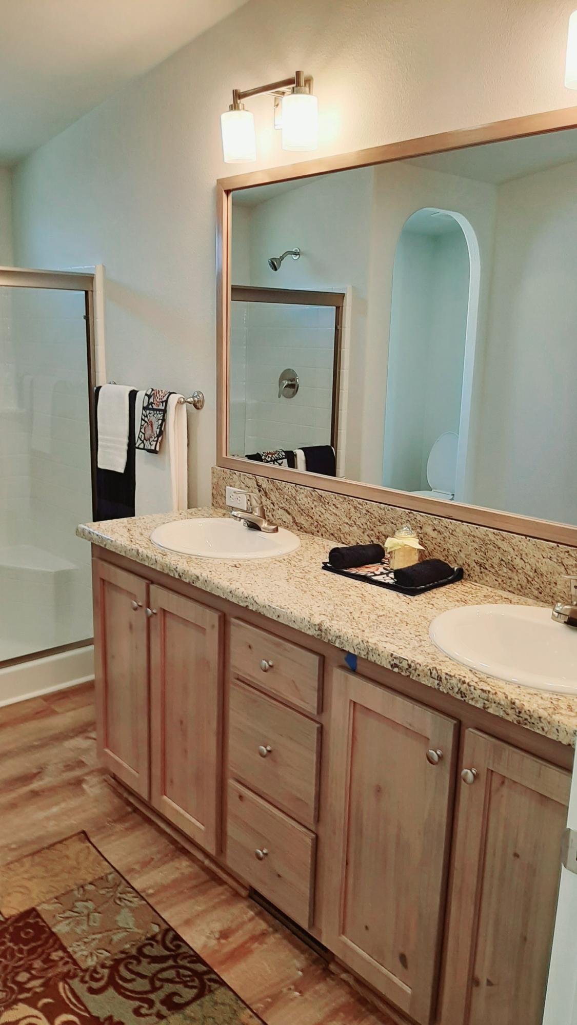 340 Old Mill Road, Unit 18 Santa Barbara, CA 93110 - Photo 12 of 22 a bathroom with a granite countertop sink and a mirror