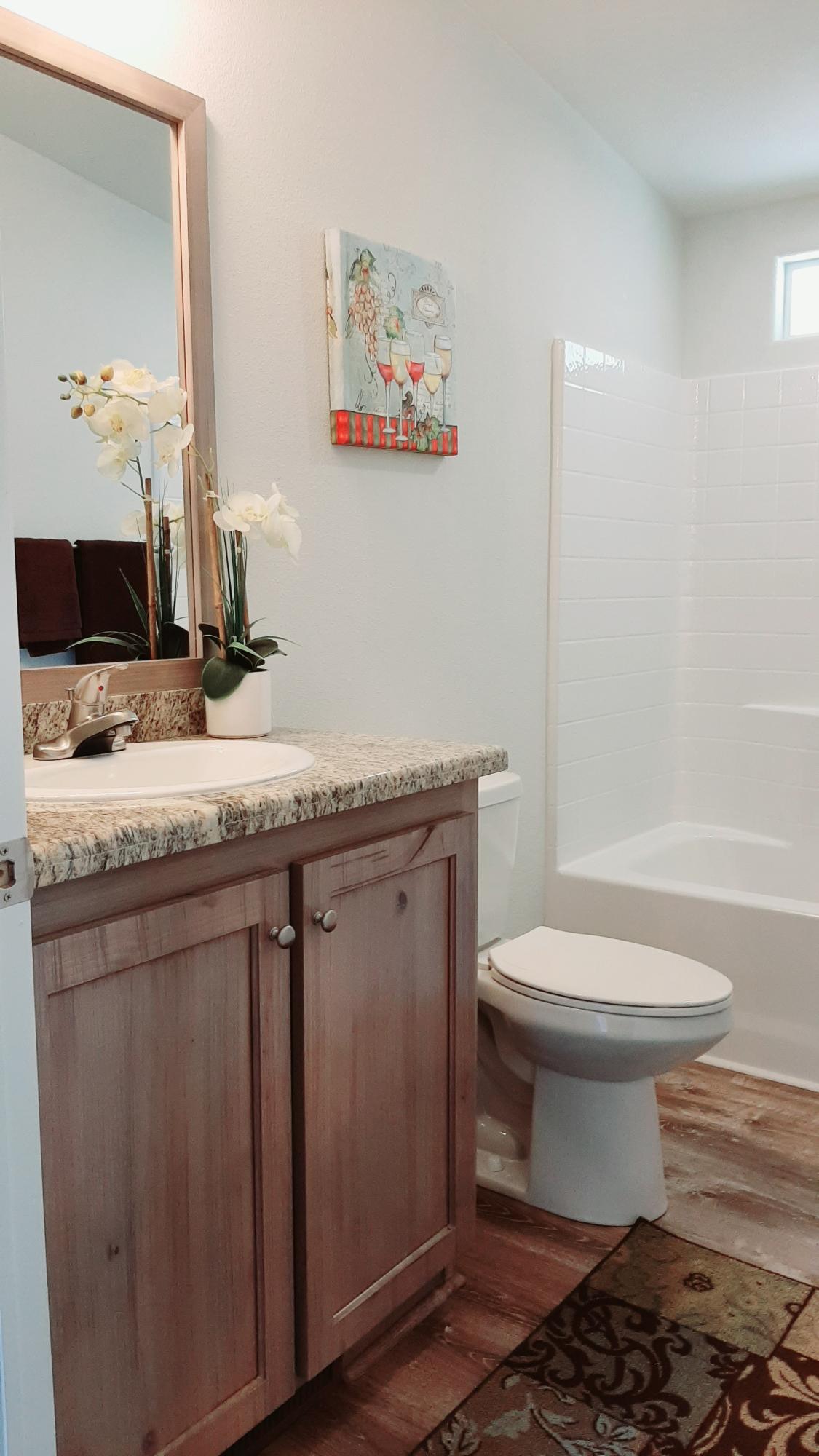340 Old Mill Road, Unit 18 Santa Barbara, CA 93110 - Photo 14 of 22 a bathroom with a granite countertop toilet sink and mirror
