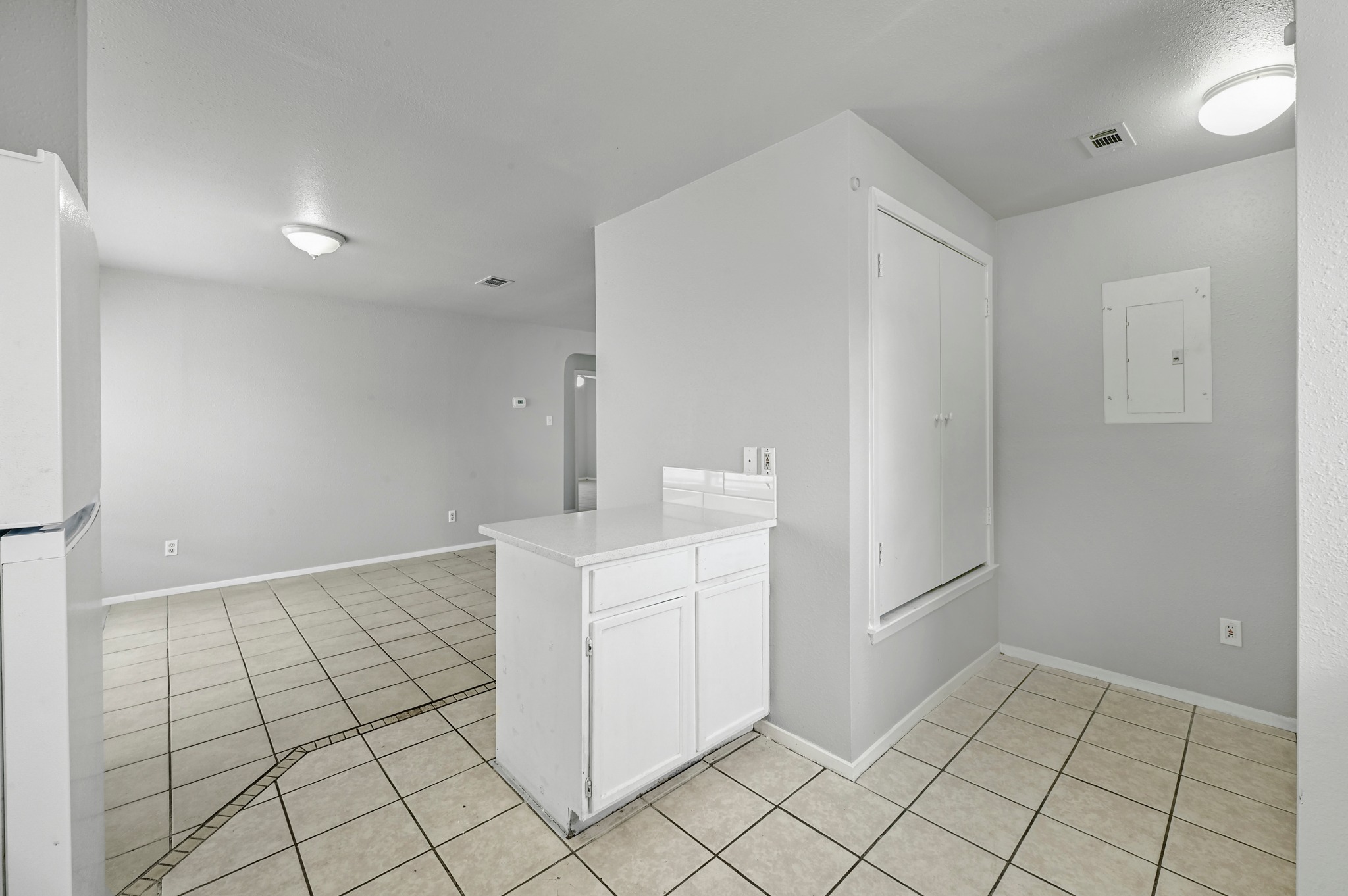2212 Katy Lane Georgetown, TX 78626 - Photo 15 of 27 The property features light gray walls, tile flooring, and a white refrigerator