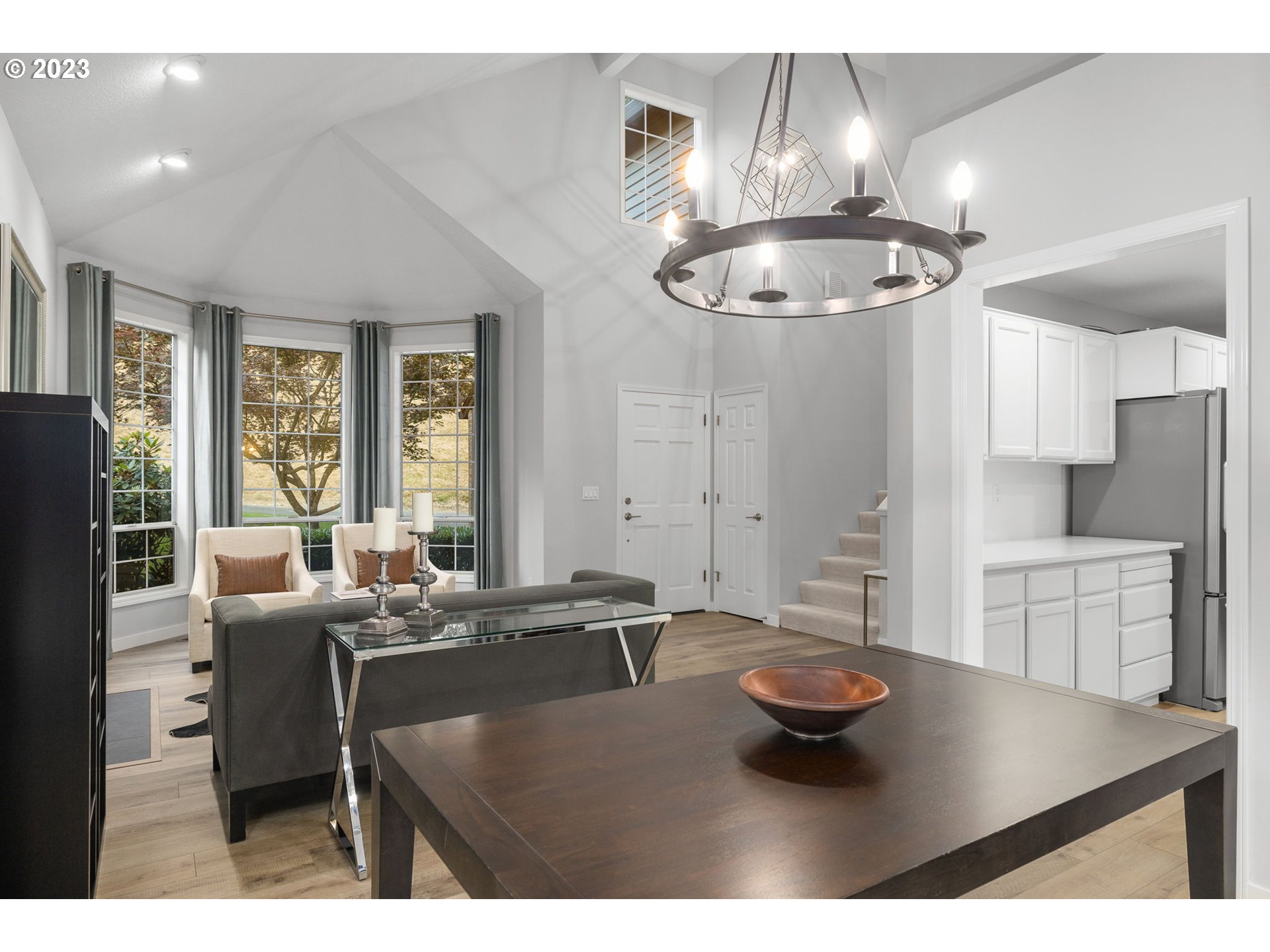 4806 Southwest Orchard Lane Portland, OR 97219 - Photo 14 of 35 a kitchen with a table chairs and chandelier