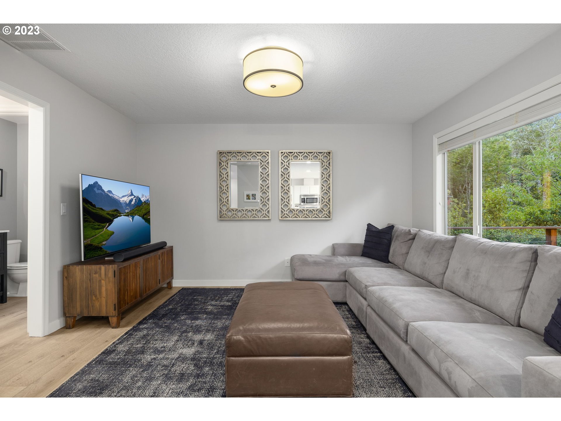 4806 Southwest Orchard Lane Portland, OR 97219 - Photo 17 of 35 a living room with furniture and a window