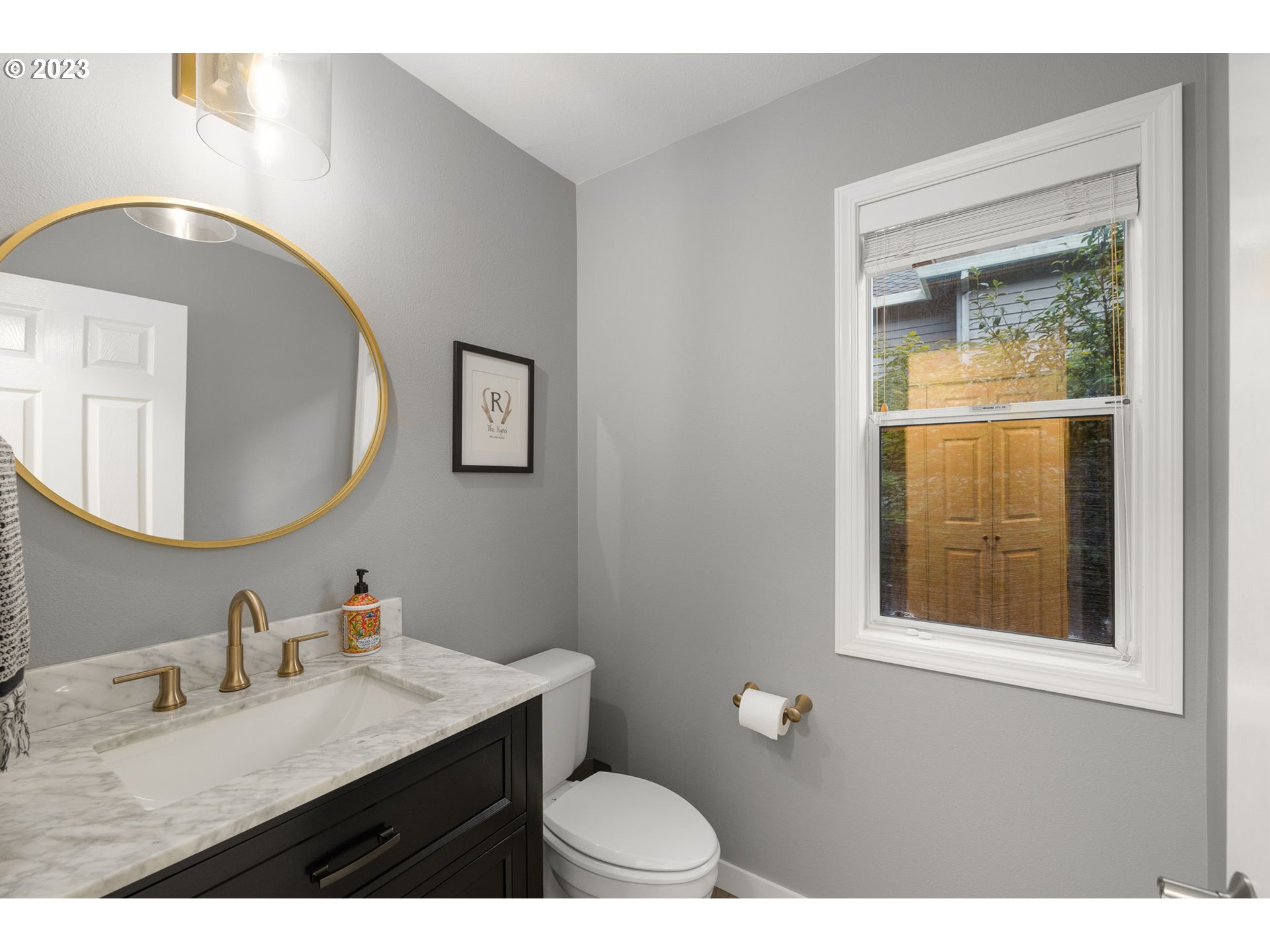 4806 Southwest Orchard Lane Portland, OR 97219 - Photo 18 of 35 a bathroom with a granite countertop toilet a sink and mirror
