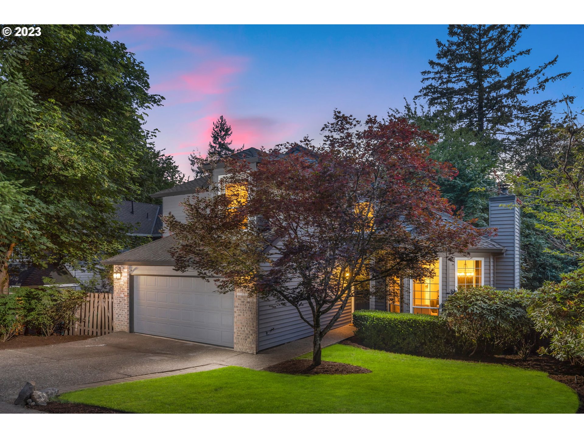 4806 Southwest Orchard Lane Portland, OR 97219 - Photo 2 of 35 a front view of a house with a yard and a tree