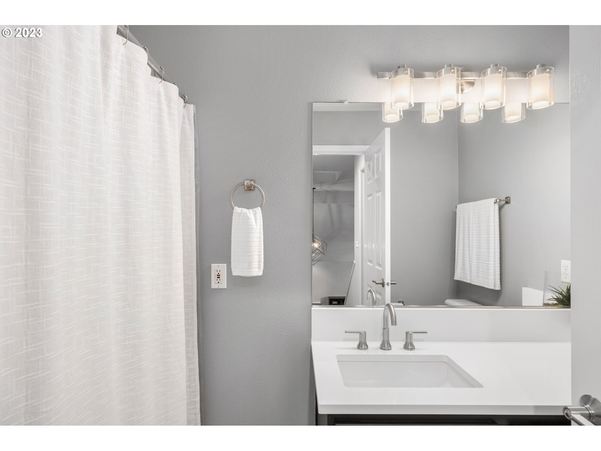 4806 Southwest Orchard Lane Portland, OR 97219 - Photo 25 of 35 a bathroom with a sink vanity and a mirror