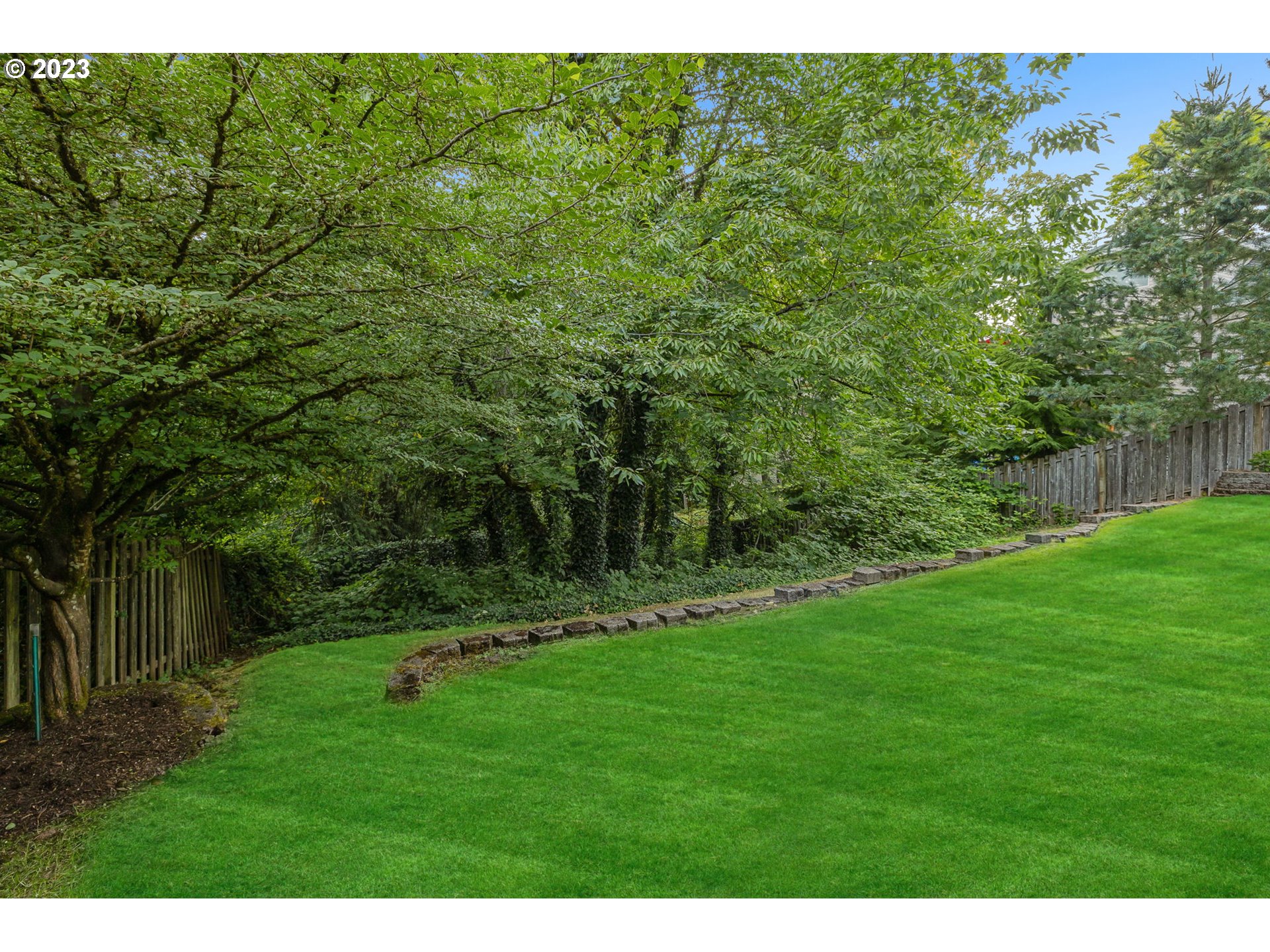 4806 Southwest Orchard Lane Portland, OR 97219 - Photo 33 of 35 a view of a grassy field with trees