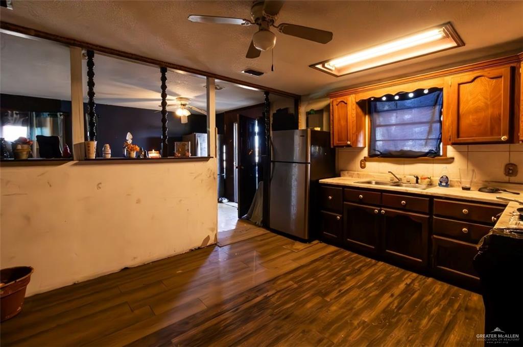 733 East Earling Road San Juan, TX 78589 - Photo 13 of 19 a kitchen with wooden floors and a refrigerator