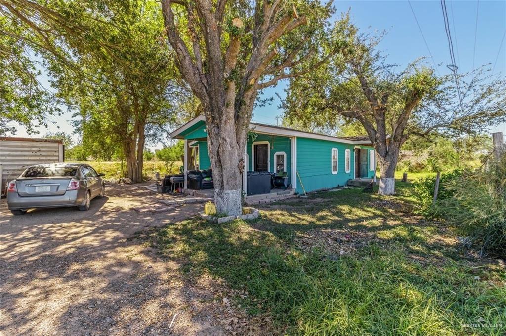 733 East Earling Road San Juan, TX 78589 - Photo 7 of 19 a view of a house with a large tree and a yard