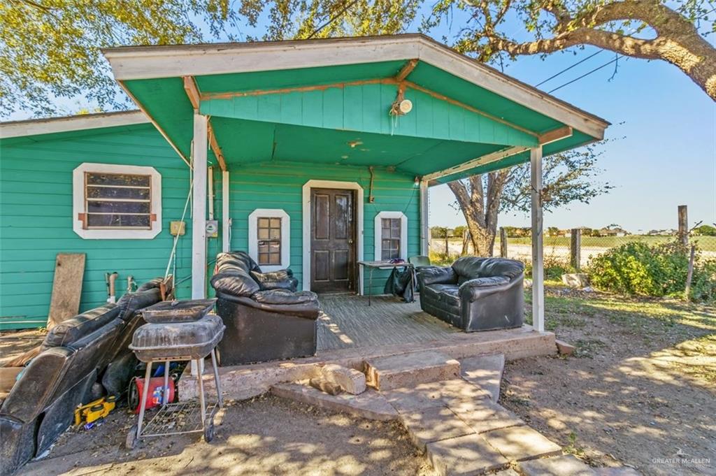 733 East Earling Road San Juan, TX 78589 - Photo 10 of 19 a view of a patio with table and chairs under an umbrella