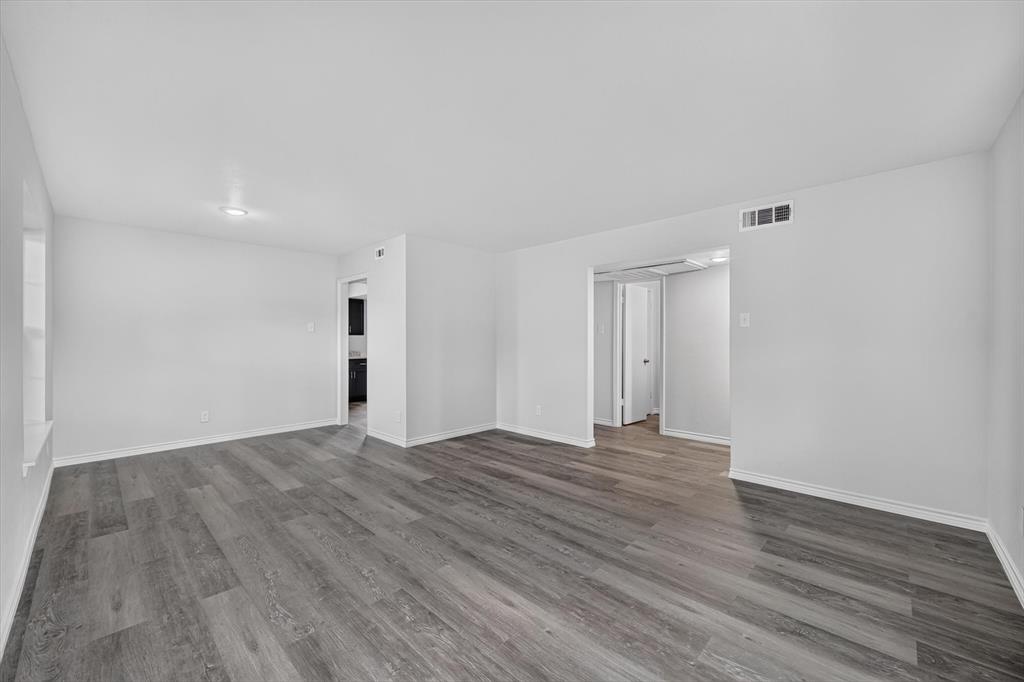 1801 East Grauwyler Road, Unit 101 Irving, TX 75061 - Photo 29 of 39 a view of an empty room with wooden floor and closet