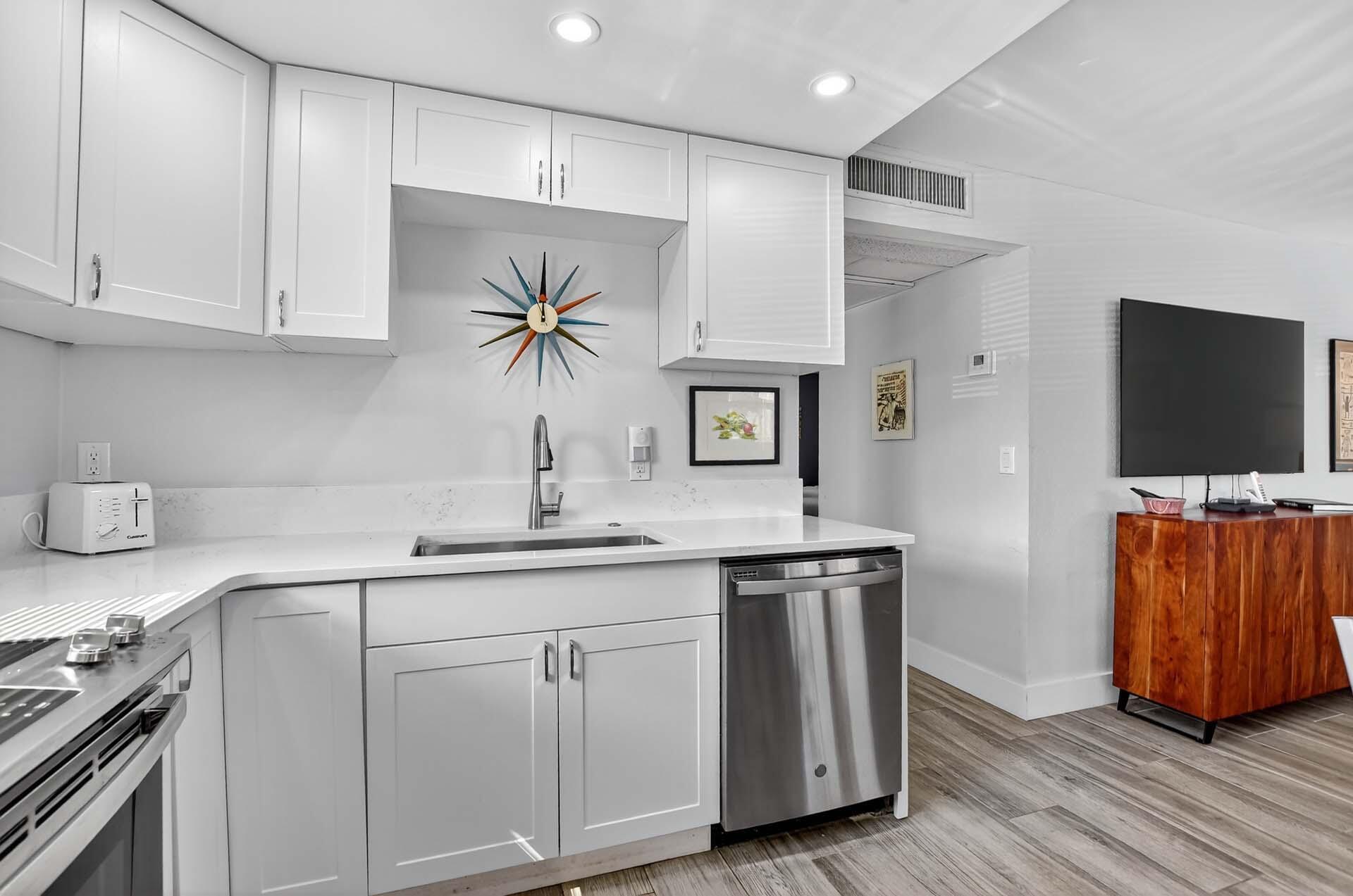 360 Flanders Drive, Unit H Delray Beach, FL 33484 - Photo 11 of 65 a kitchen with stainless steel appliances granite countertop a sink a stove and a wooden floors