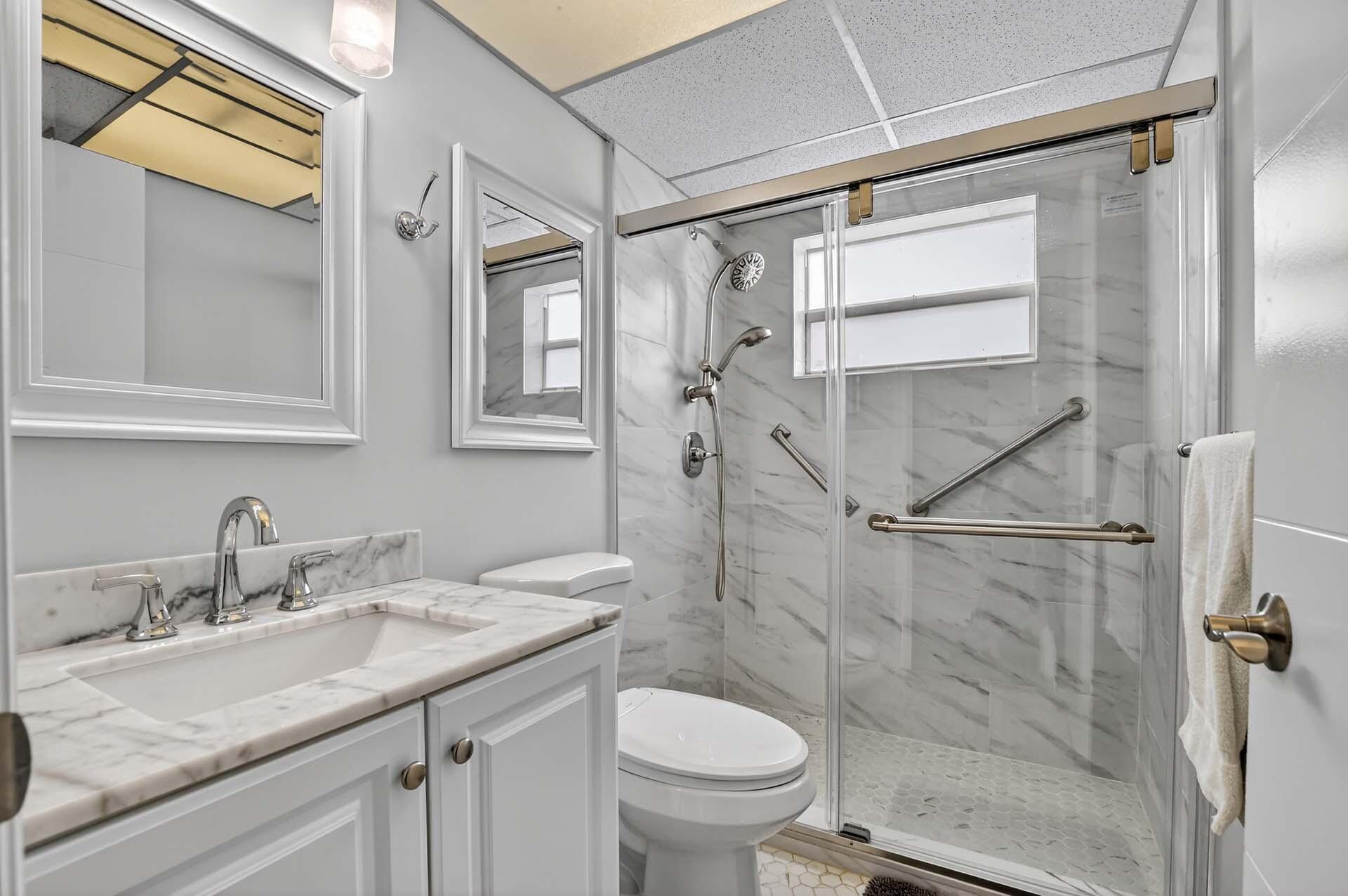 360 Flanders Drive, Unit H Delray Beach, FL 33484 - Photo 13 of 65 a bathroom with a granite countertop sink toilet and shower