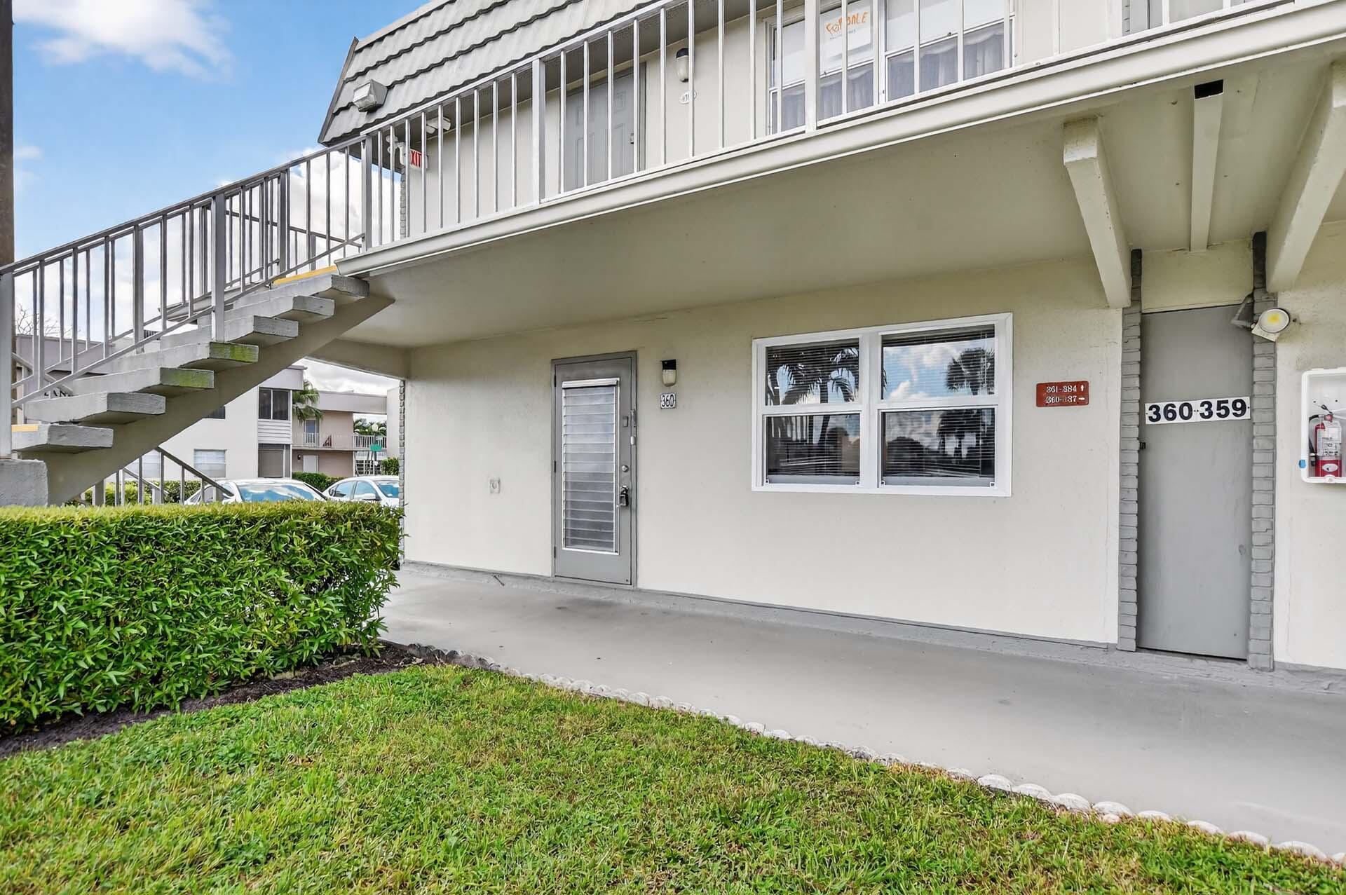 360 Flanders Drive, Unit H Delray Beach, FL 33484 - Photo 2 of 65 a view of a house with a small yard