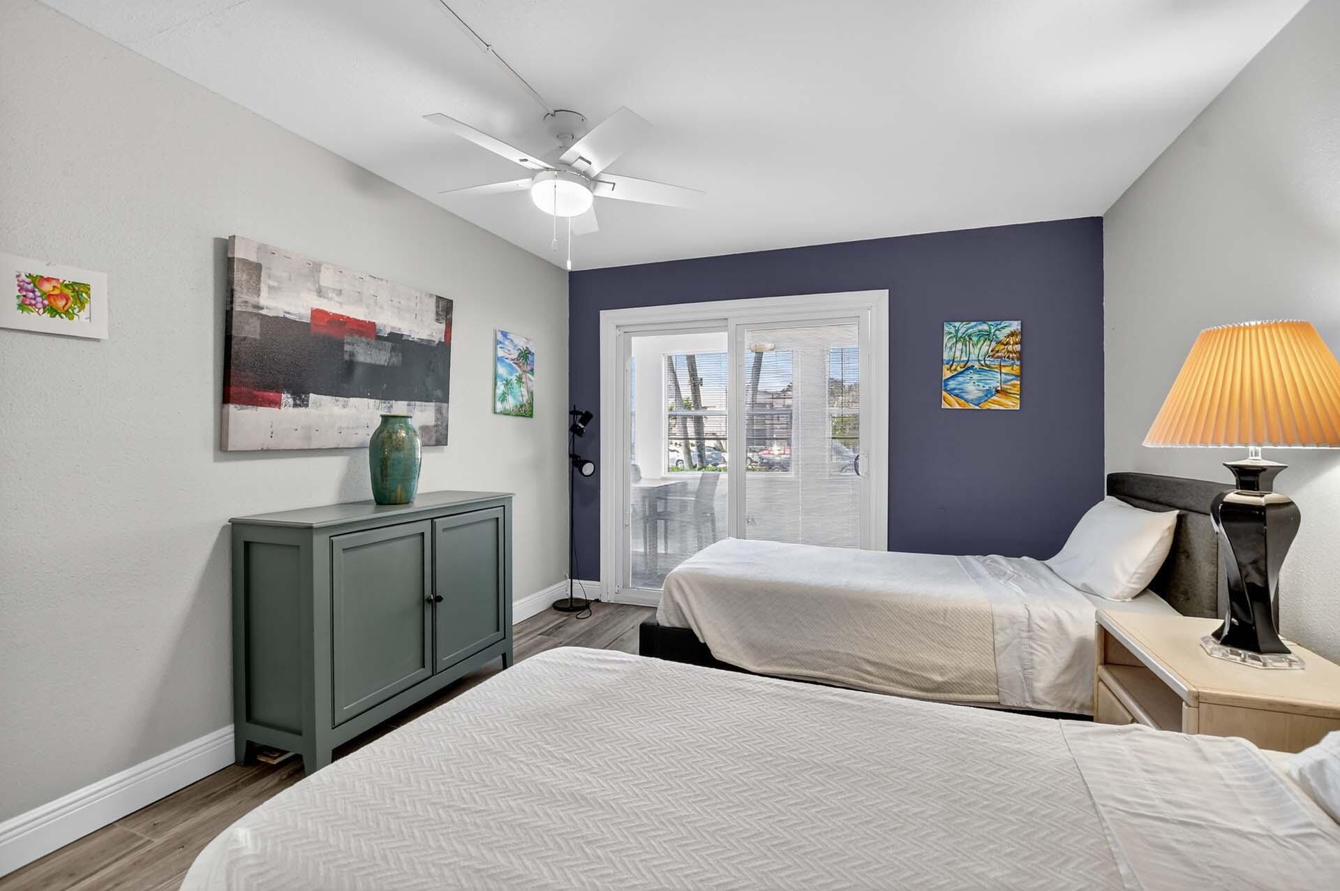 360 Flanders Drive, Unit H Delray Beach, FL 33484 - Photo 21 of 65 a bedroom with a bed and a flat screen tv